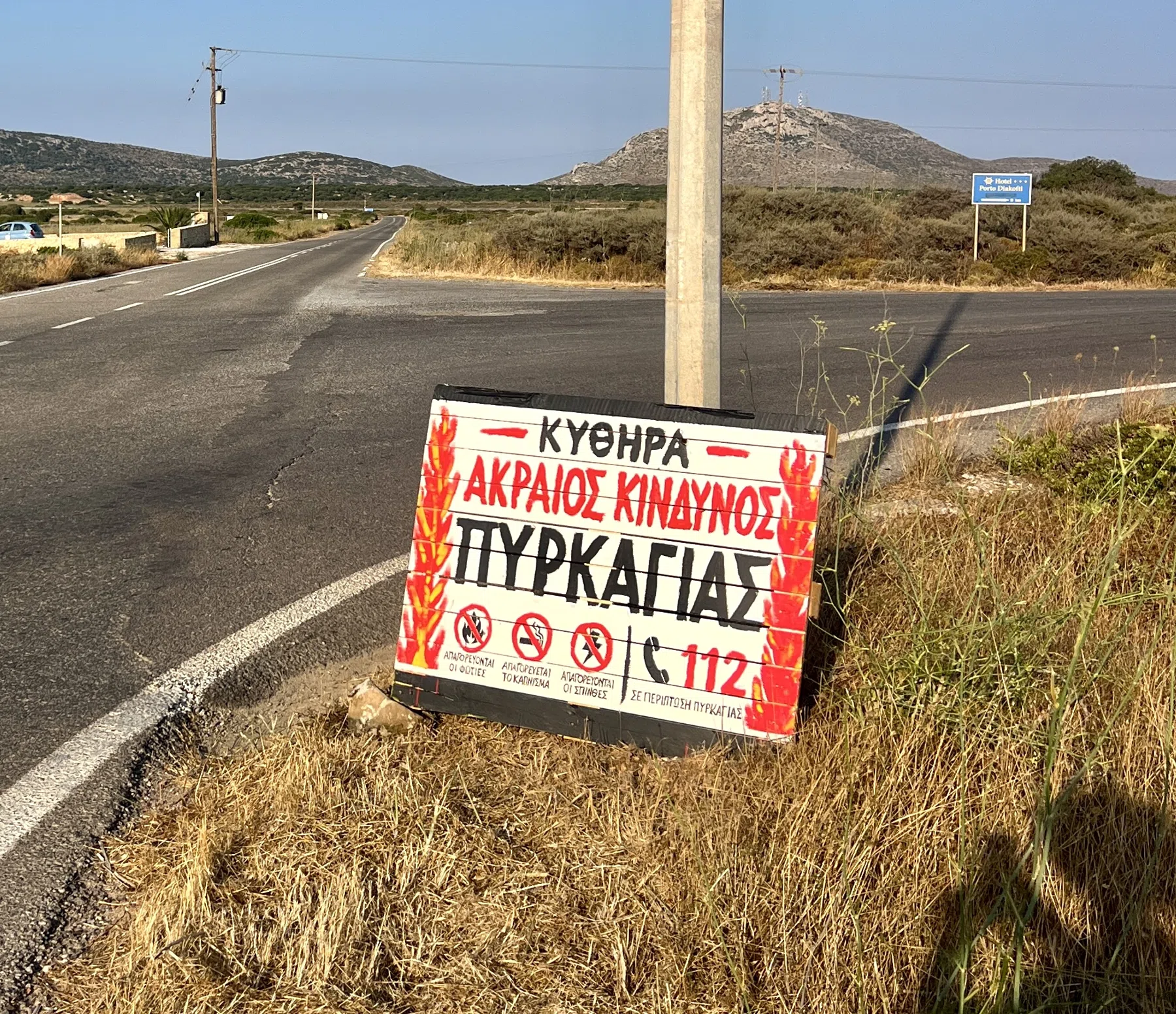 A handmade Greek extreme fire danger sign at a road junction