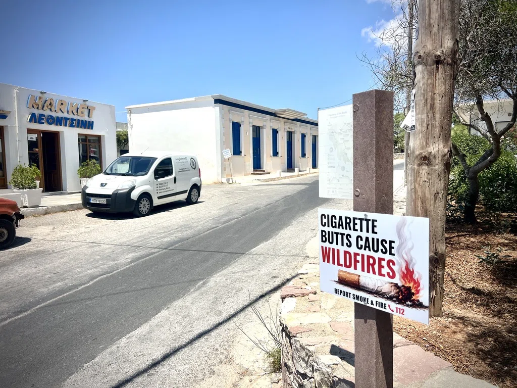 An English cigarette-butt fire warning beside a village street